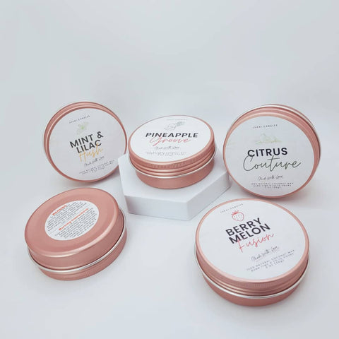 Set of small containers with lids on a light gray background