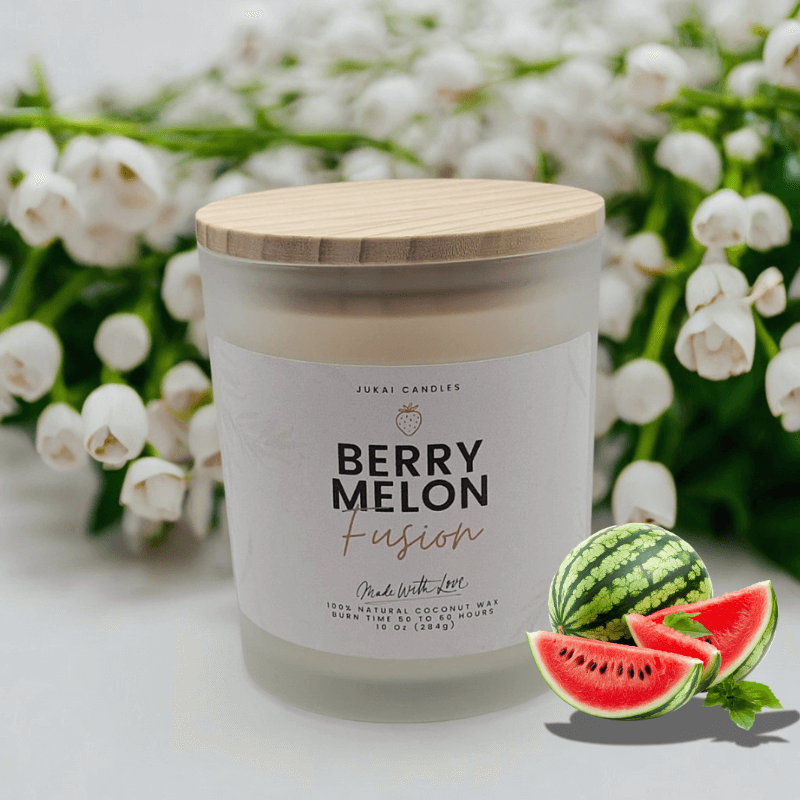 Candle labeled 'Berry Melon Fusion' with watermelon slices and a bouquet of white flowers in the background.