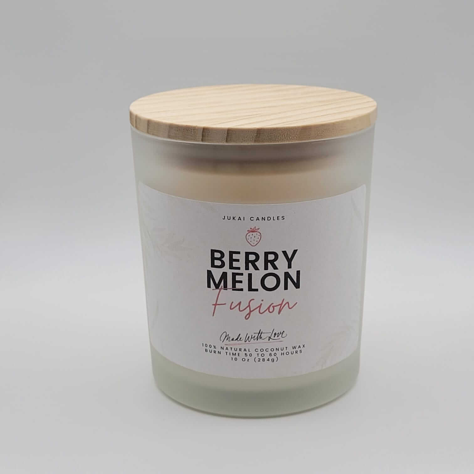 Candle with a wooden lid labeled 'Berry Melon Fusion' on a gray background