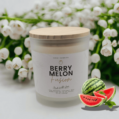 Candle labeled 'Berry Melon Fusion' with watermelon slices and a bouquet of white flowers in the background.