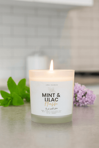 Candle labeled 'Mint & Lilac' with a blurred background